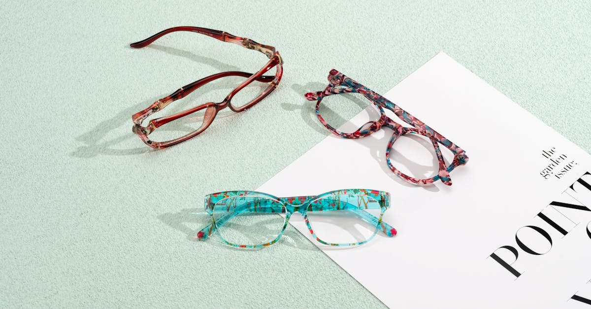 A person wearing Eyeary glasses-style eye training device while looking at a smartphone screen