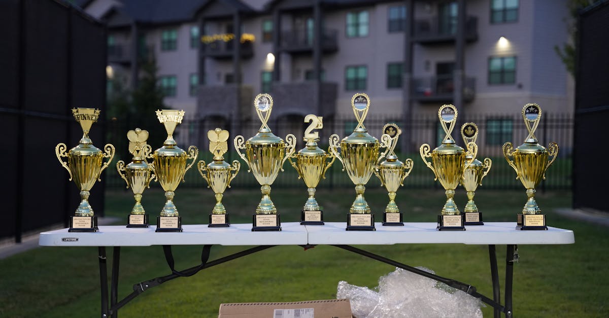 Stage at Hollywood awards show featuring Oscar statues and DGA PGA trophies