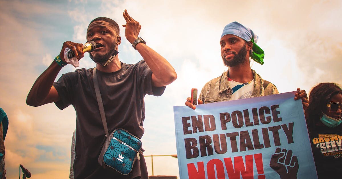 Crowd of protesters marching in downtown Minneapolis holding signs against ICE after fatal shooting