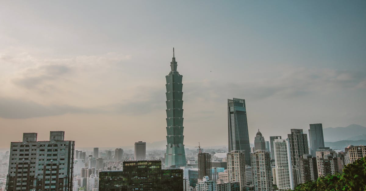 Alex Honnold stands at the base of Taipei 101 tower preparing for free solo climb