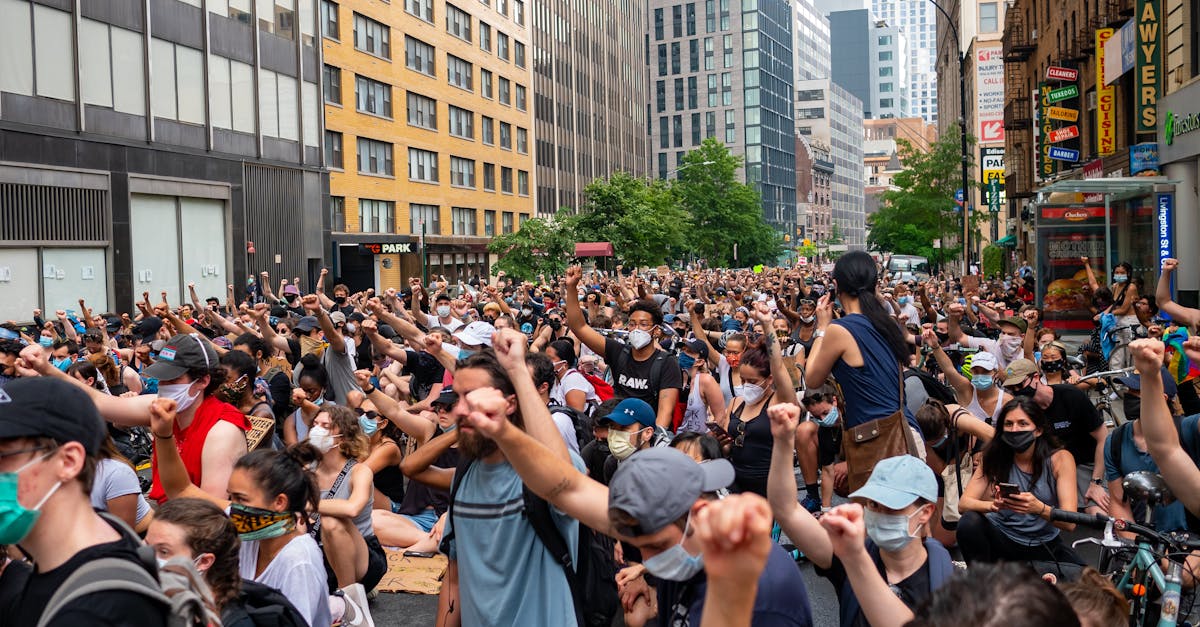 Large crowd of protesters marching in downtown Salt Lake City against ICE policies