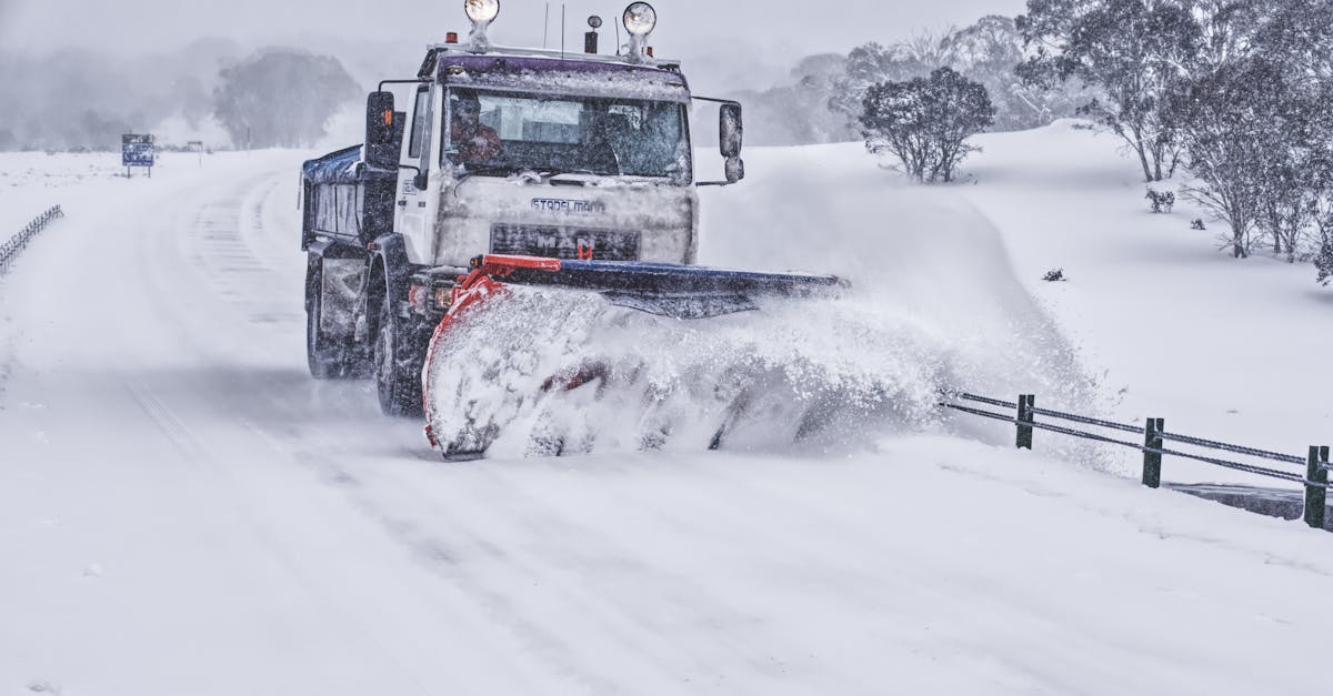 Snow-covered streets in Boston during the 2026 East Coast blizzard with emergency plows at work