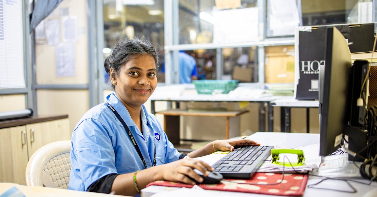 Corporate office environment with employees working at desks with computer monitors
