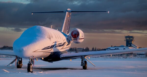 Snow blankets runways at a major US airport during Winter Storm Hernando causing flight cancellations