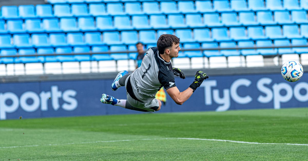 Liverpool goalkeeper Alisson Becker makes a diving save during a match at Anfield