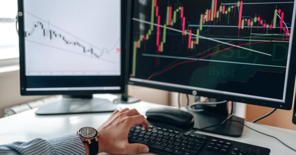 Traders at Asia stock exchange watch screens showing mixed markets after Nvidia-driven US decline