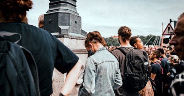 Crowd marching in Lyon with portraits of Quentin Deranque during memorial rally