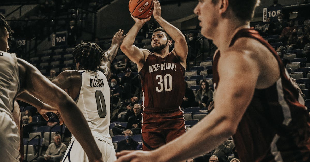 Iowa Hawkeyes players celebrate victory on court after beating Northwestern in college basketball game