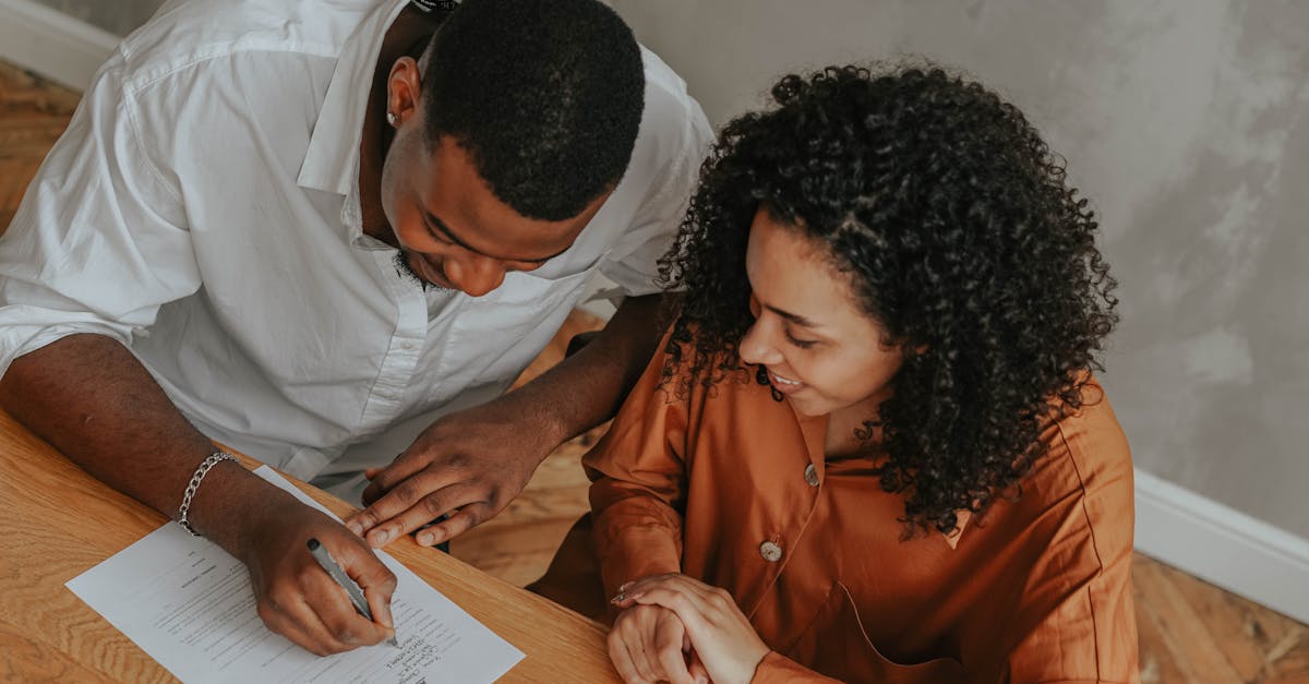 A married couple reviewing property documents together at their dining table
