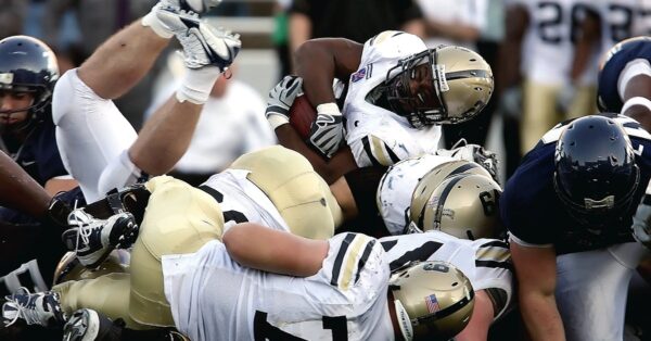 NFL players executing a short-yardage play during a football game