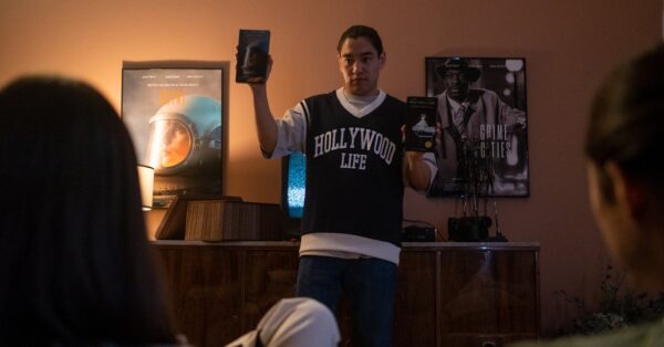 Promotional poster for Rajinikanth and Kamal Haasan film KHxRK showing vintage car and legends initials