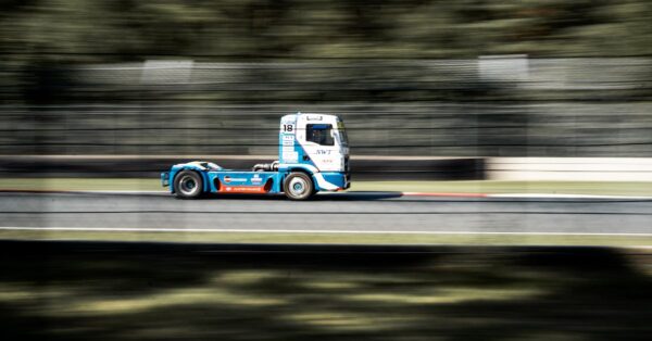 Rivian R1T electric pickup activating Sport Mode on a winding road