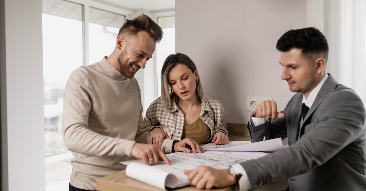 Two adults reviewing documents together at a table, discussing shared property matters