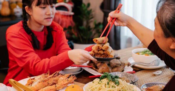 Elderly Chinese senior enjoying a balanced meal with family